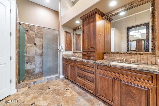 bathroom featuring tasteful backsplash, vanity, and a shower with shower door