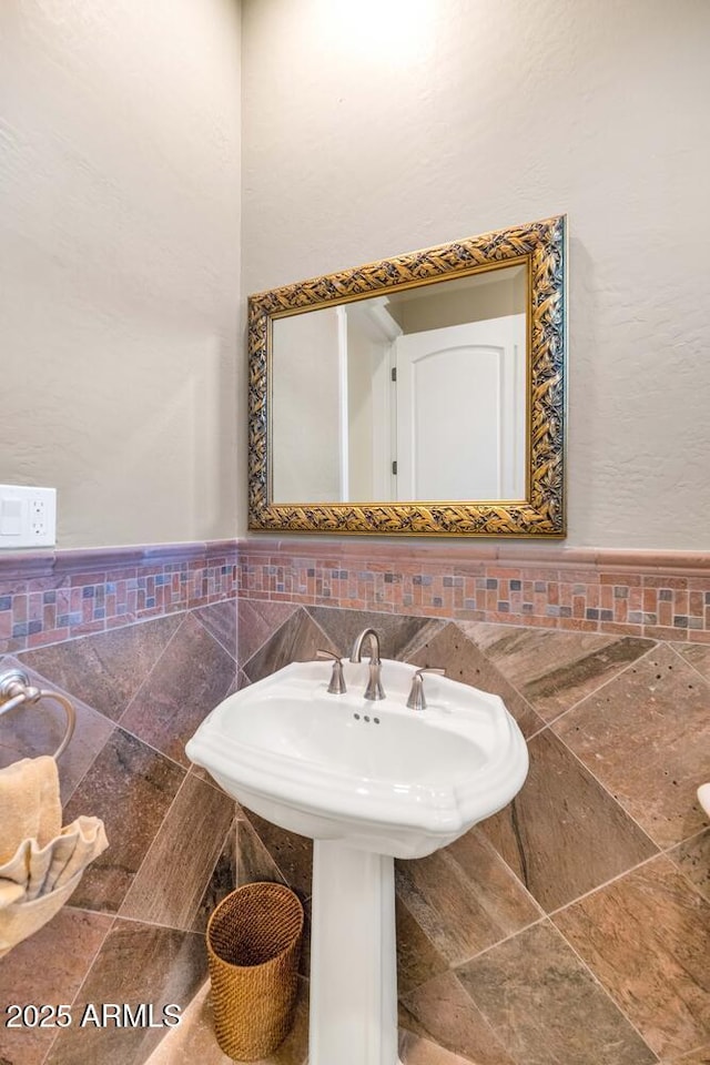 bathroom with tile walls