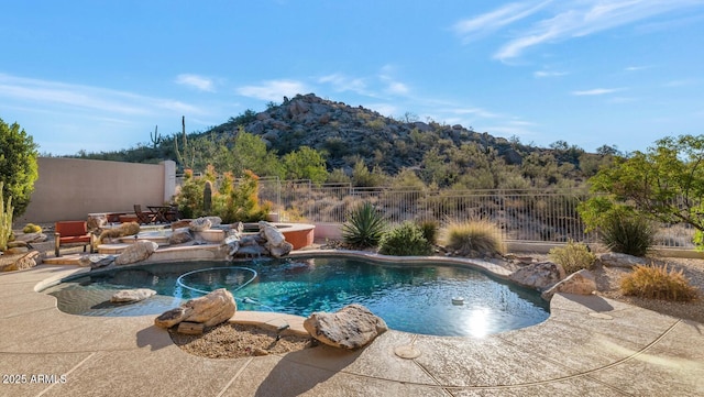 view of swimming pool featuring a mountain view, a patio area, and pool water feature