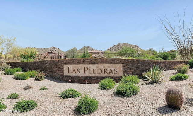 community sign with a mountain view