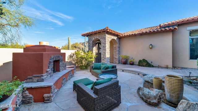 view of patio featuring an outdoor living space with a fireplace