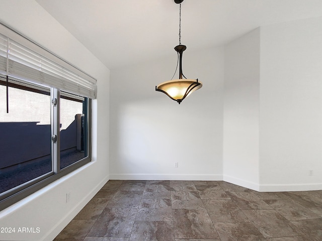 spare room featuring lofted ceiling