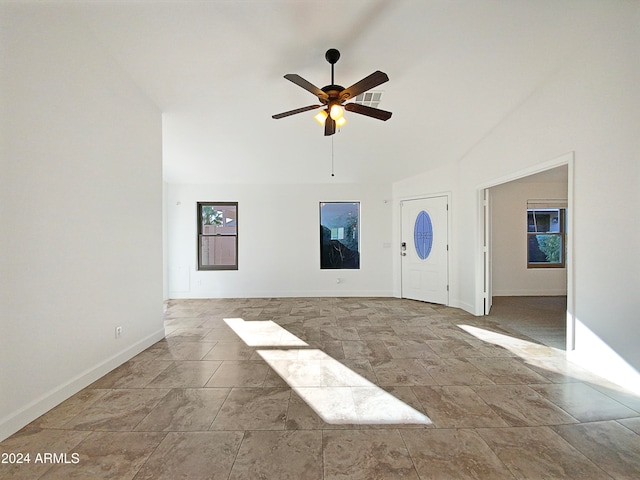 unfurnished living room featuring vaulted ceiling and ceiling fan