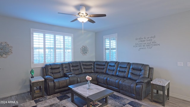 living room featuring hardwood / wood-style flooring, ceiling fan, and a healthy amount of sunlight