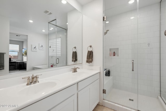 bathroom with vanity, tile patterned floors, and a shower with door