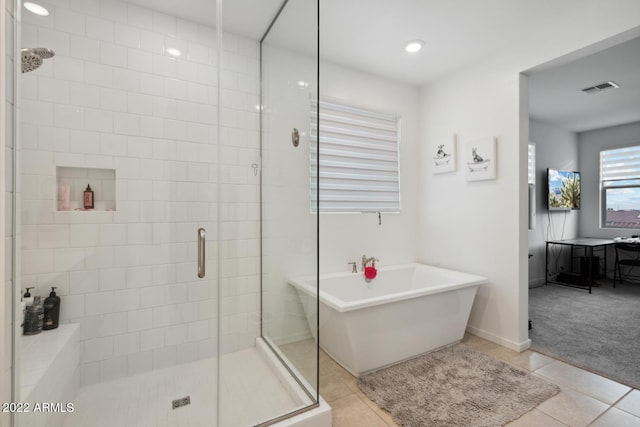 bathroom featuring tile patterned flooring and independent shower and bath