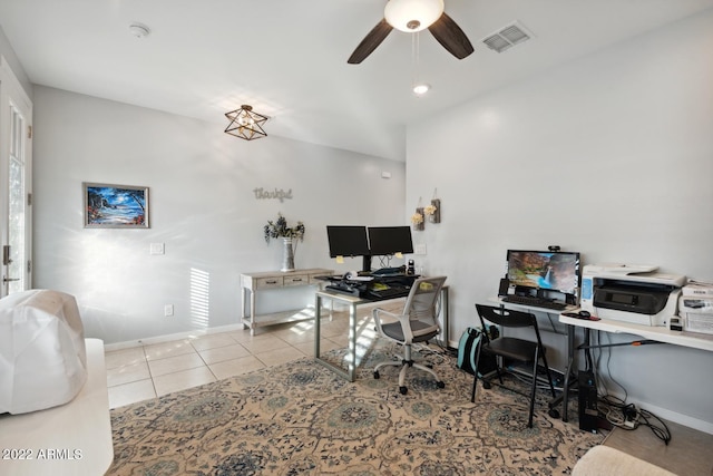 tiled home office featuring ceiling fan