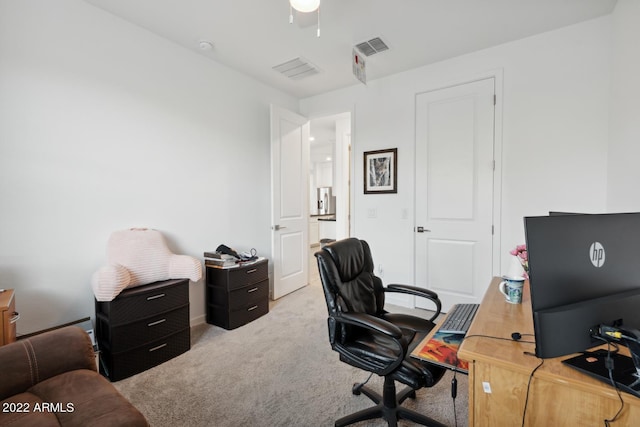 carpeted office space featuring ceiling fan