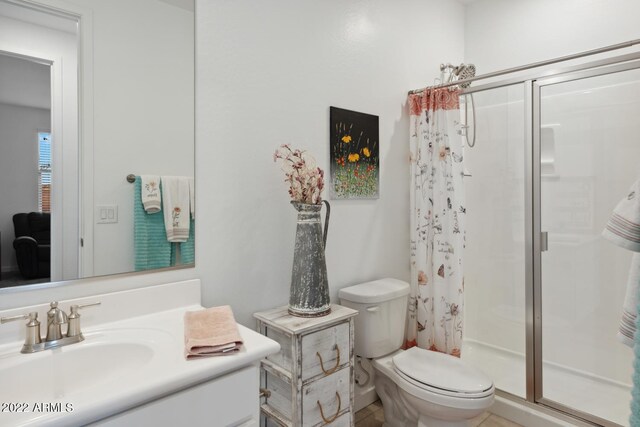 bathroom with vanity, toilet, and curtained shower