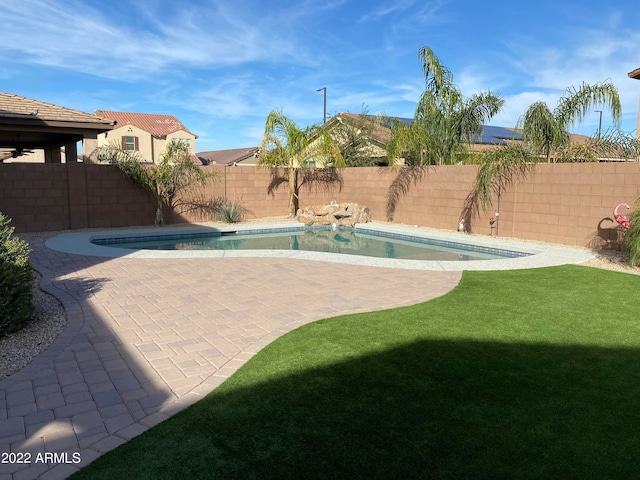 view of swimming pool with a lawn and a patio