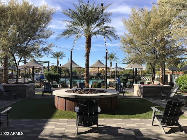 view of property's community featuring a gazebo and an outdoor fire pit