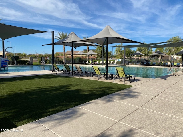 view of pool featuring a yard