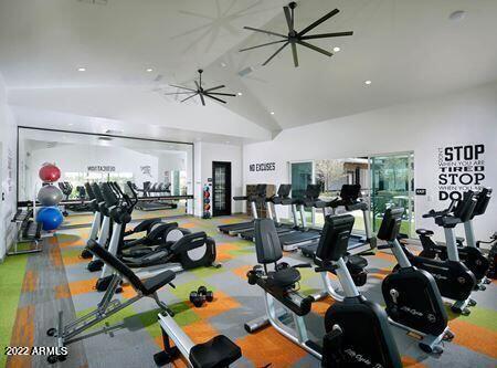 gym featuring high vaulted ceiling and ceiling fan