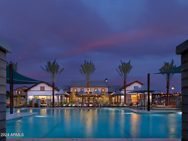 view of pool at dusk