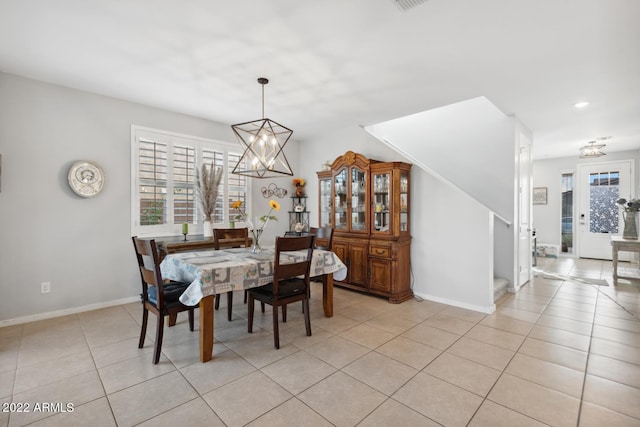 dining area featuring light tile patterned floors and a chandelier