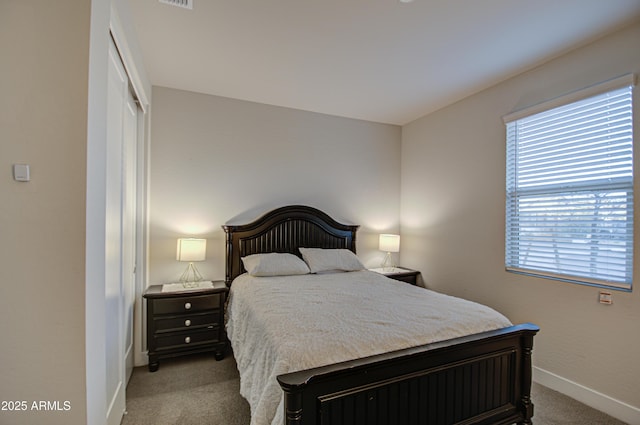 bedroom with carpet, visible vents, baseboards, and a closet