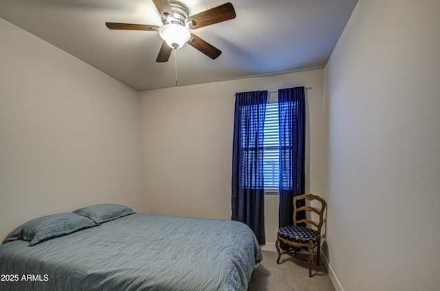 carpeted bedroom with ceiling fan and baseboards