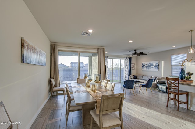 dining room featuring wood tiled floor, visible vents, baseboards, and recessed lighting