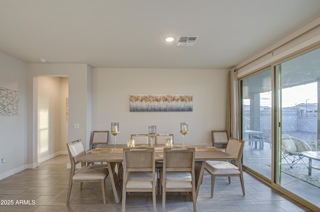 dining room featuring a wealth of natural light, visible vents, and baseboards