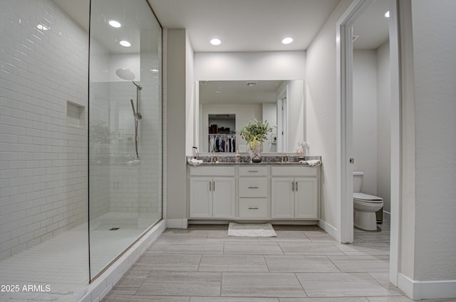 bathroom featuring baseboards, toilet, and walk in shower