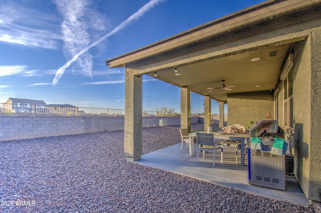 view of patio / terrace featuring visible vents, outdoor dining area, a fenced backyard, and a ceiling fan