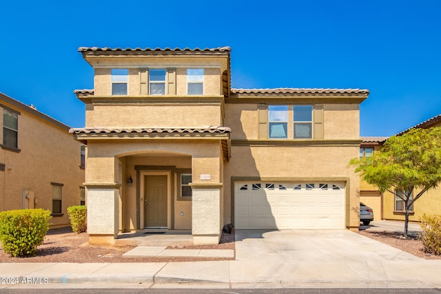 mediterranean / spanish-style home with a garage