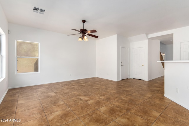 unfurnished room with ceiling fan