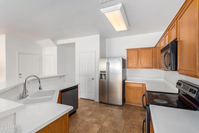 kitchen with light tile patterned floors, stainless steel appliances, and sink