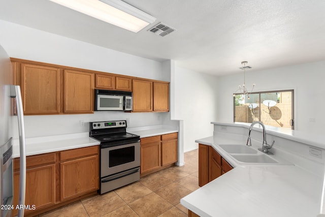 kitchen with pendant lighting, light tile patterned floors, an inviting chandelier, sink, and appliances with stainless steel finishes