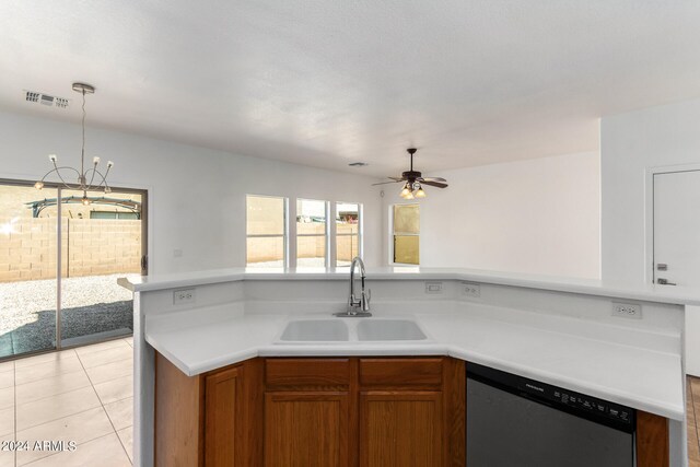 kitchen with light tile patterned floors, dishwasher, decorative light fixtures, ceiling fan with notable chandelier, and sink