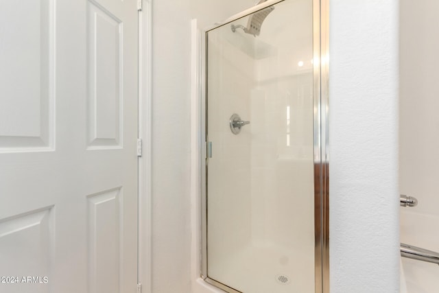 bathroom featuring a shower with shower door