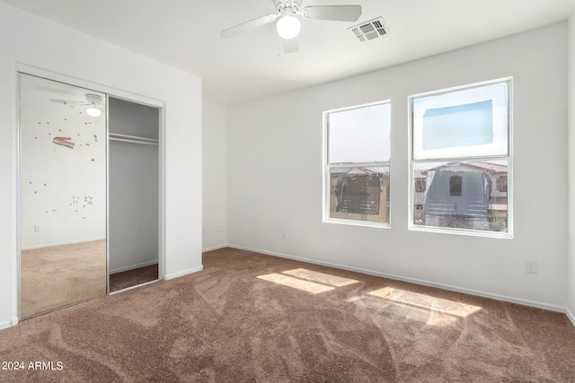 unfurnished bedroom with a closet, ceiling fan, and carpet