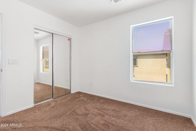 unfurnished bedroom with a closet and carpet