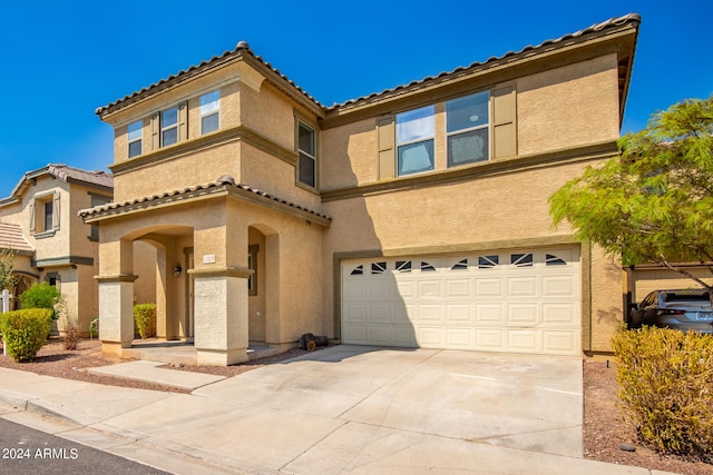 mediterranean / spanish house featuring a garage