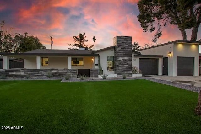 view of front facade featuring a garage and a lawn