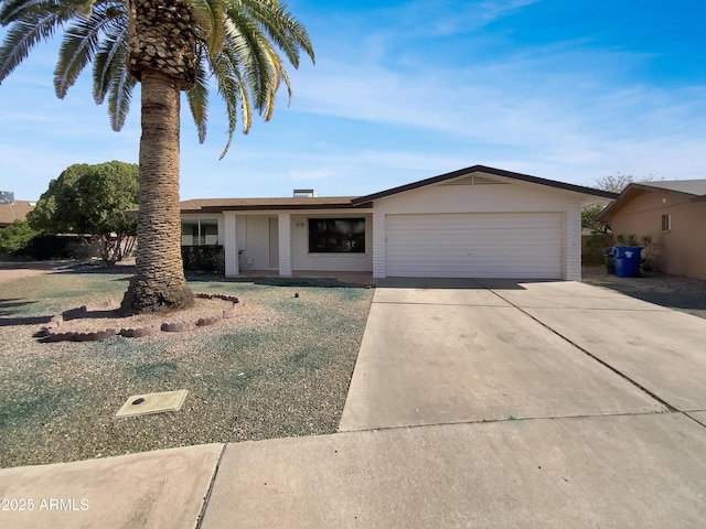 ranch-style house with driveway, brick siding, and an attached garage