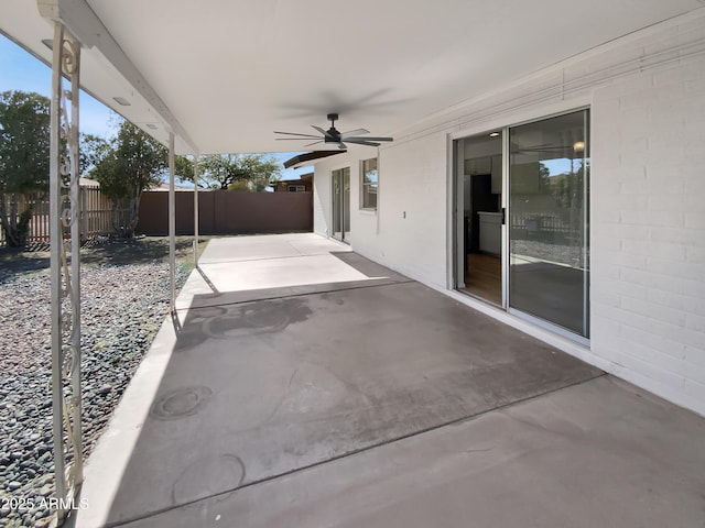 view of patio / terrace with ceiling fan and fence