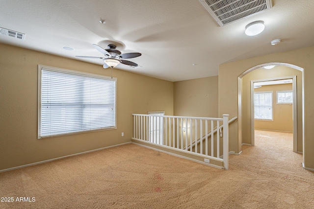 unfurnished room featuring light carpet and ceiling fan