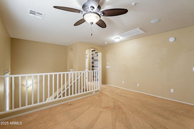 carpeted empty room featuring ceiling fan