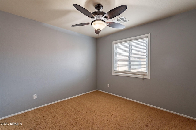 carpeted empty room featuring ceiling fan