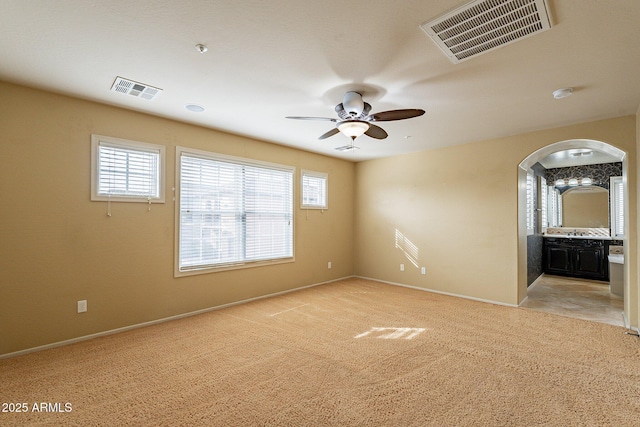 carpeted spare room with ceiling fan