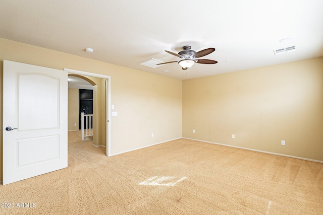 unfurnished room featuring light carpet and ceiling fan