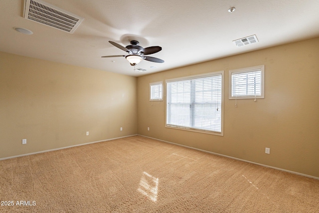 carpeted spare room with ceiling fan