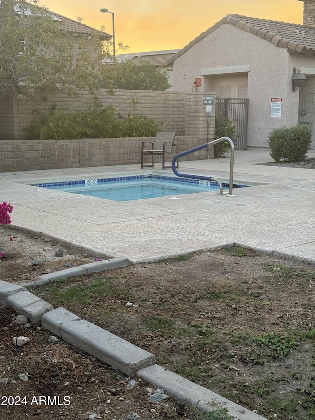 view of pool at dusk