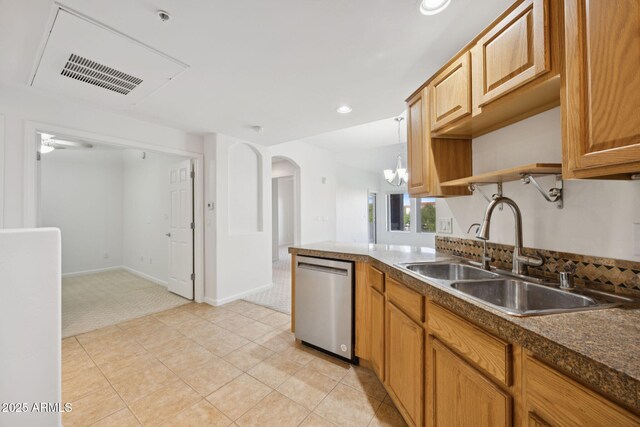 14000 N 94th St Unit 3198, Scottsdale, AZ 85260 - kitchen featuring stainless steel dishwasher, light colored carpet, a chandelier, dark countertops, and arched walkways