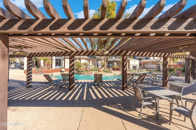 view of patio / terrace featuring pool water feature, a community pool, and a pergola