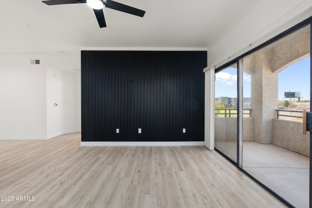 empty room with ornamental molding, ceiling fan, and light hardwood / wood-style floors