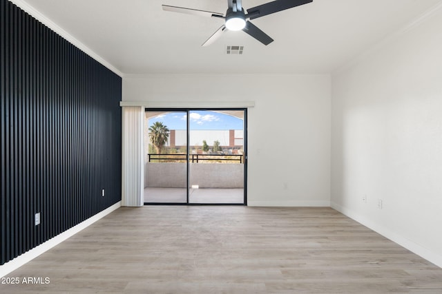 empty room featuring crown molding, ceiling fan, and light hardwood / wood-style floors