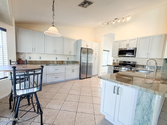 17371 N 86th Ave, Peoria, AZ 85382 - kitchen with stainless steel appliances, a sink, a peninsula, stone counters, and plenty of natural light