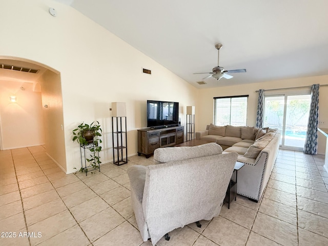 17371 N 86th Ave, Peoria, AZ 85382 - living room with arched walkways, light tile patterned floors, ceiling fan, high vaulted ceiling, and baseboards